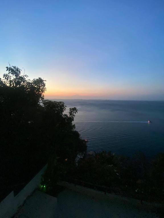 a view of the ocean at sunset from a house at Apartamento no Corredor da Vitoria in Salvador