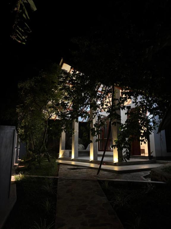 a night view of a building with lights at Rock Harmony Villa in Hikkaduwa