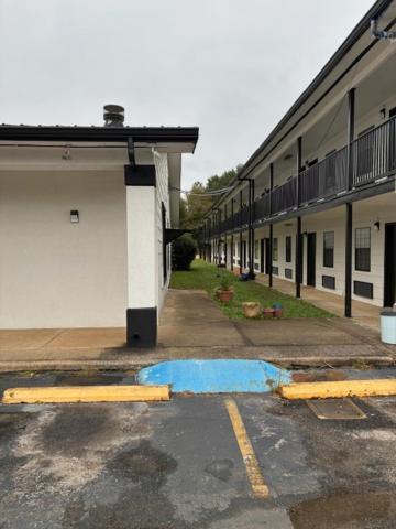 an empty parking lot in front of a building at Suite Stay - Talladega in Talladega