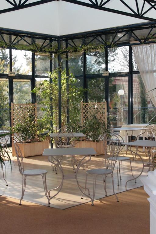 a patio with tables and chairs in a building at Résidence de Tourisme Vacances Bleues Villa Regina in Arcachon