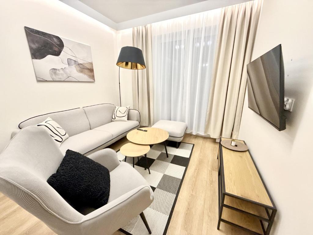 a living room with a couch and a table at Apartament Kaszmir in Kętrzyn