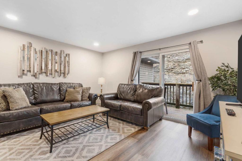 a living room with a couch and a table at Rockwall Duo - Cottage & Lodge Combo in Branson