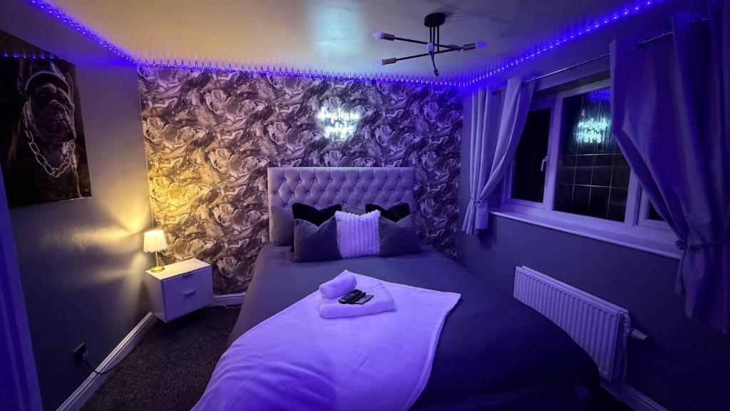 a purple bedroom with a bed with a tray on it at A Star Living in Liversedge