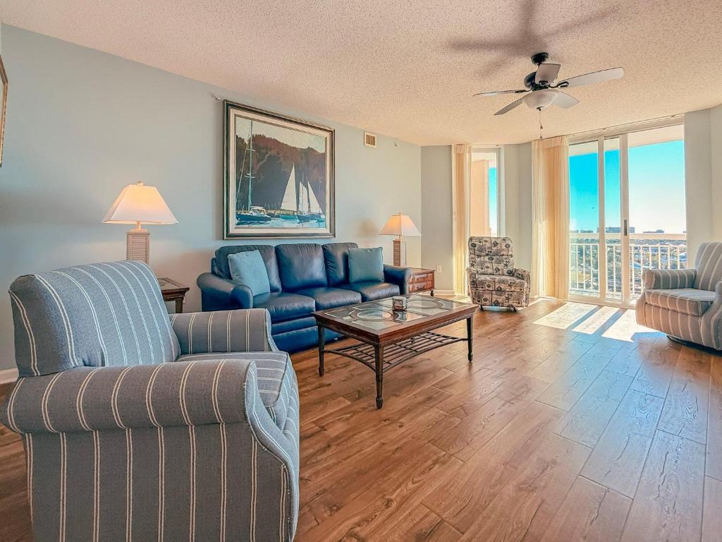 a living room with a couch and a table at Barefoot North Tower - 1203 in Myrtle Beach