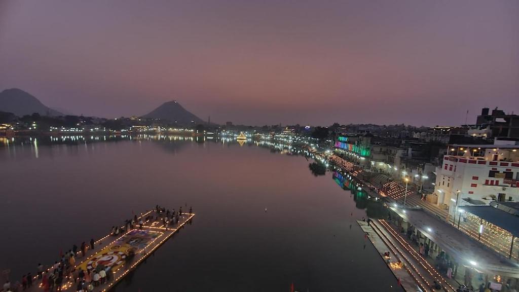 a view of a city with a river at night at Anand hostel in Pushkar