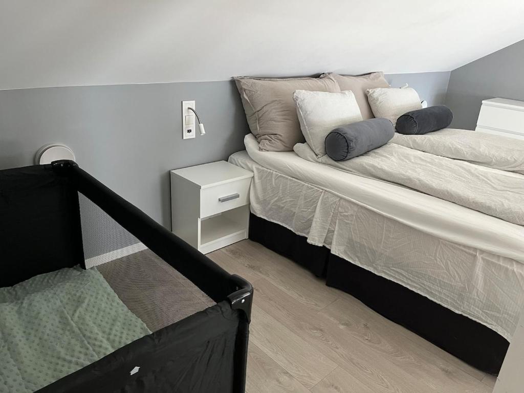 a bed with pillows on it in a bedroom at House by the fjord - Ocean view and jacuzzi in Forland