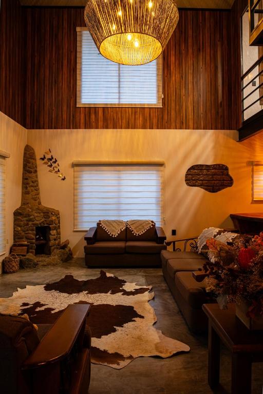 a living room with a couch and a chandelier at The Brown House in Oaxaca City