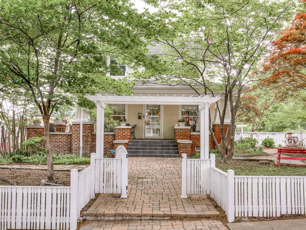 een wit hek voor een huis bij Spacious 4BR Tulsa Home with Patio in Tulsa