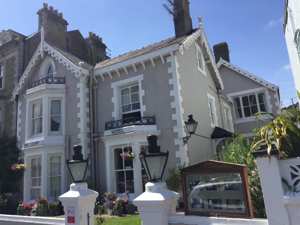 a large white house with a sign in front of it at Bay Court in Llandudno