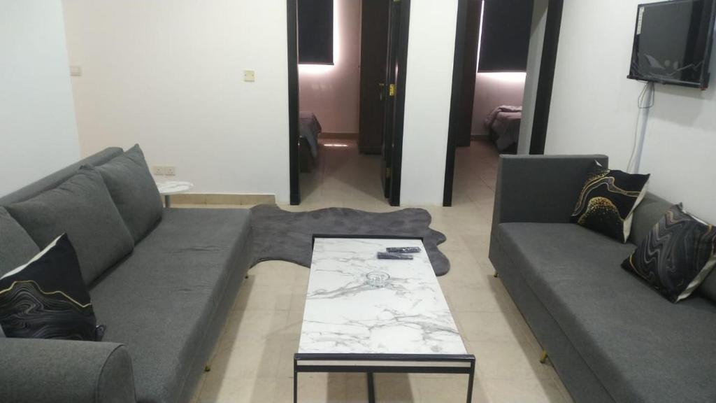 a living room with a couch and a coffee table at شقه غرفتين وصاله الاربعين in Riyadh