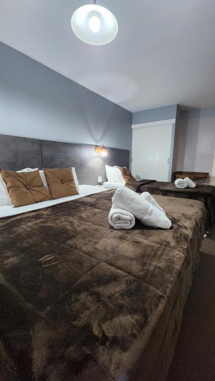 a bedroom with two beds with pillows on it at Essencial Hotel Spa in Mendoza