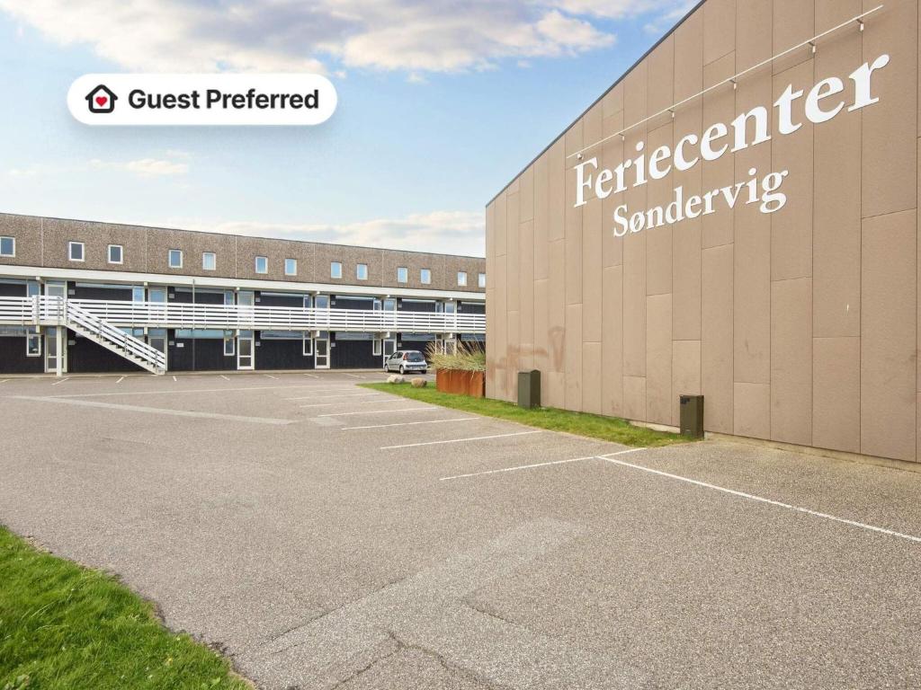 a building with a car parked in a parking lot at 4 star holiday home in Ringkøbing-By Traum in Ringkøbing