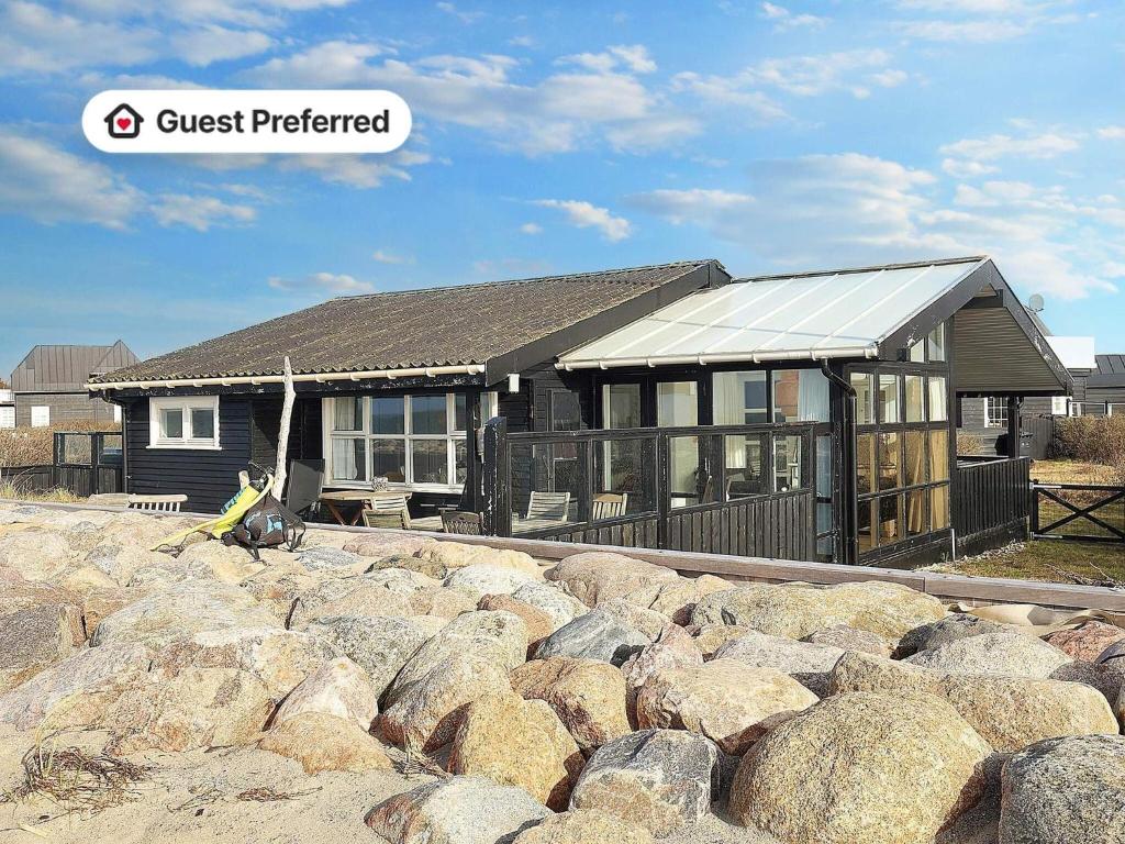 a house with a bunch of rocks in front of it at 4 star holiday home in Karrebæksminde-By Traum in Karrebæksminde