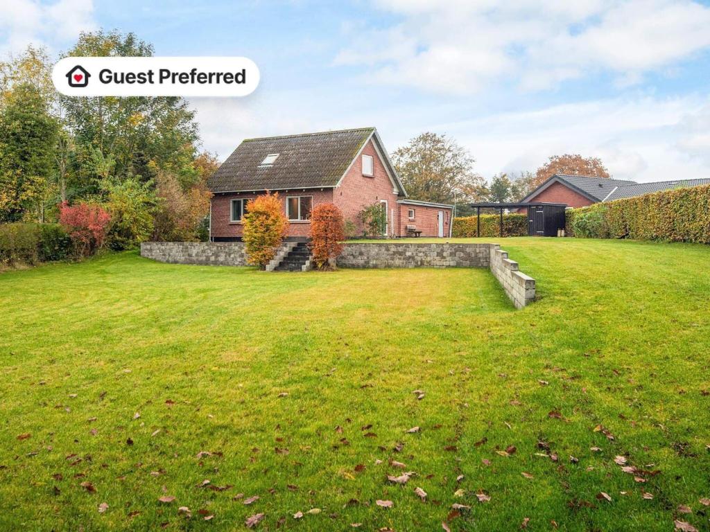 a large yard in front of a house at 4 person holiday home in Ansager in Ansager