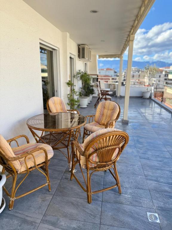 a patio with a table and chairs on a balcony at Urban Elegance - Trikala in Tríkala