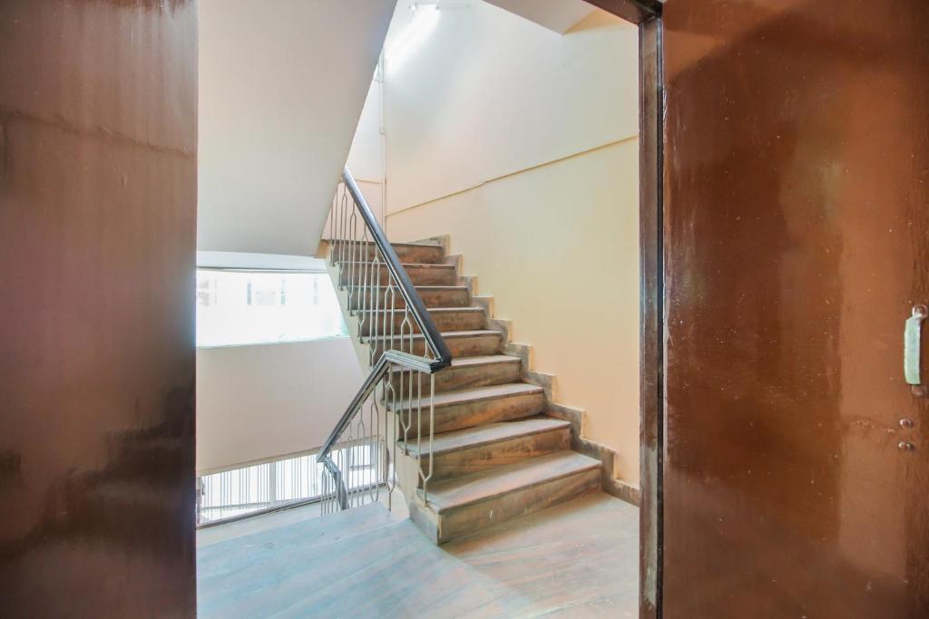 a staircase in an old building with a metal railing at Collection O Hotel Kavya Guest House in Jaipur