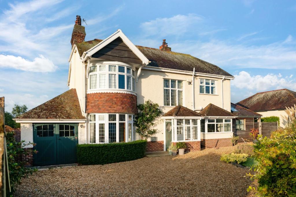 a large white house with a blue door at Summerfield in Conwy