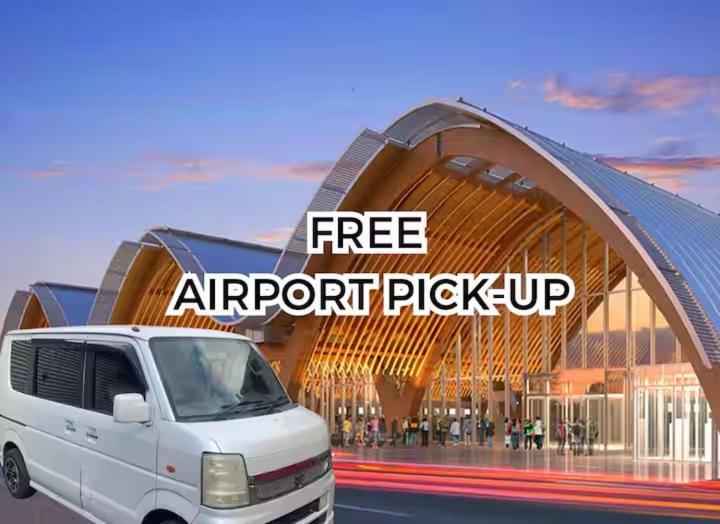a white van parked in front of a large building at Bolo Airport Dormitel in Mactan Cebu International