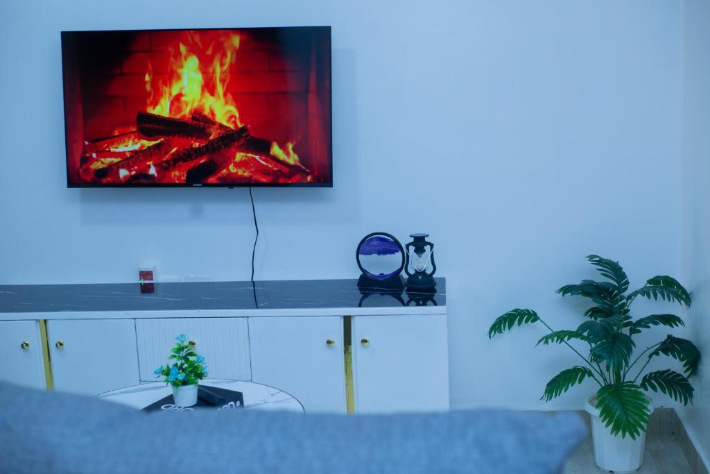 a living room with a fire in a fireplace at Urban Nest suites in Kisii