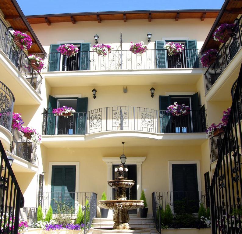 a building with flowers on balconies and a fountain at Aurelia Vatican Apartments in Rome