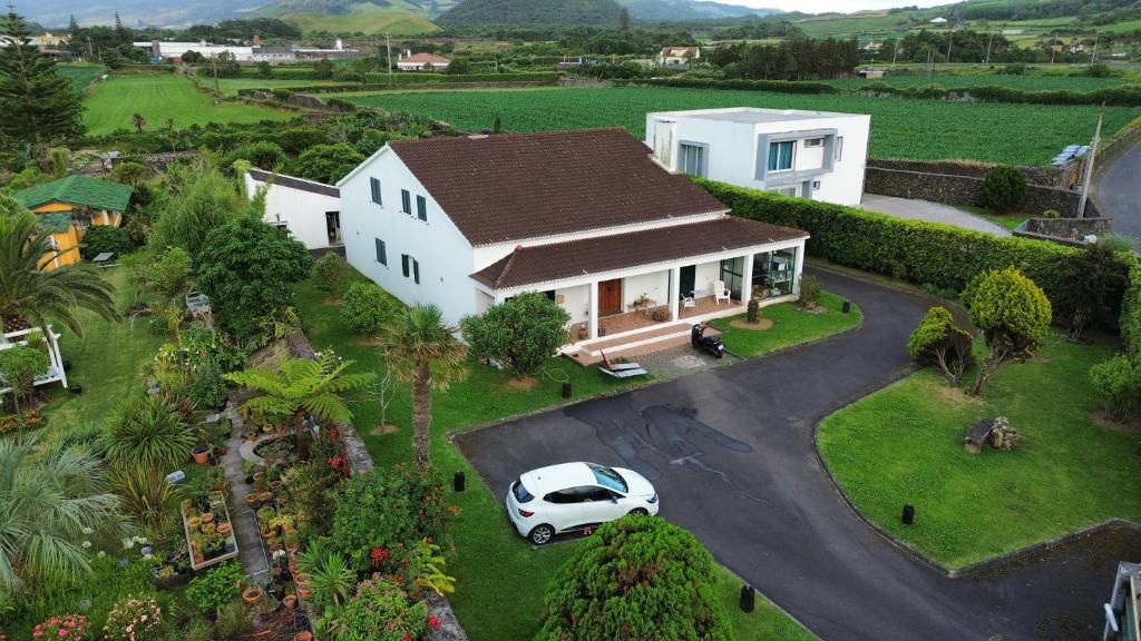 a white car parked in front of a house at Sermar in Rabo de Peixe