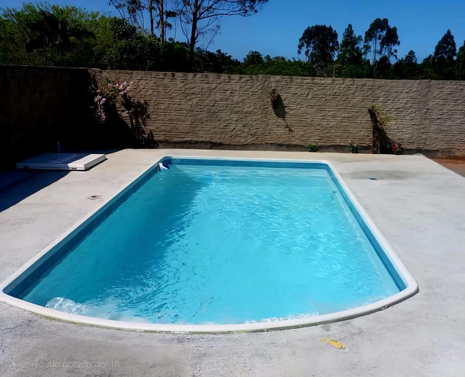a swimming pool on top of a patio at Recanto do Sossego in Barra Velha