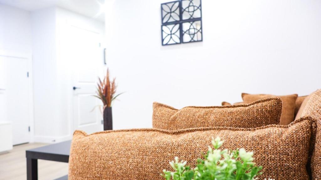 a living room with a couch with pillows at A true Home away from Home in Calgary