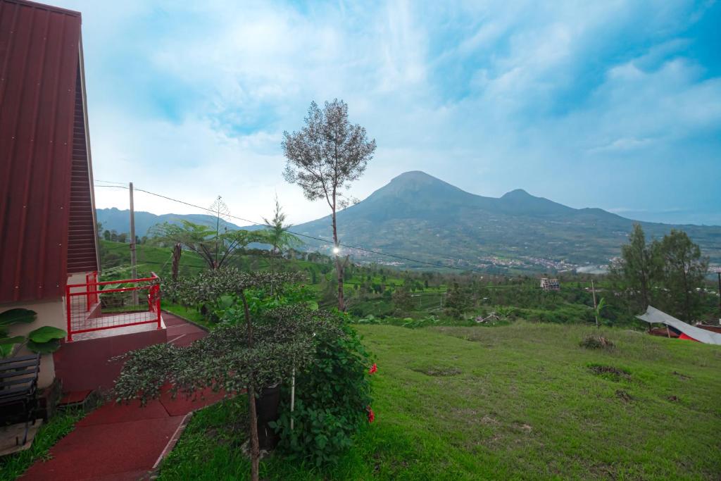 a balcony of a house with a view of a mountain at Khanzana Cabin and Camp in Kejajar
