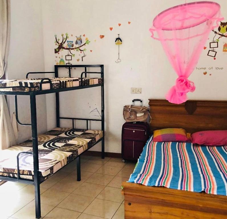 a bedroom with two bunk beds and a pink ceiling at Negombo hostel in Negombo