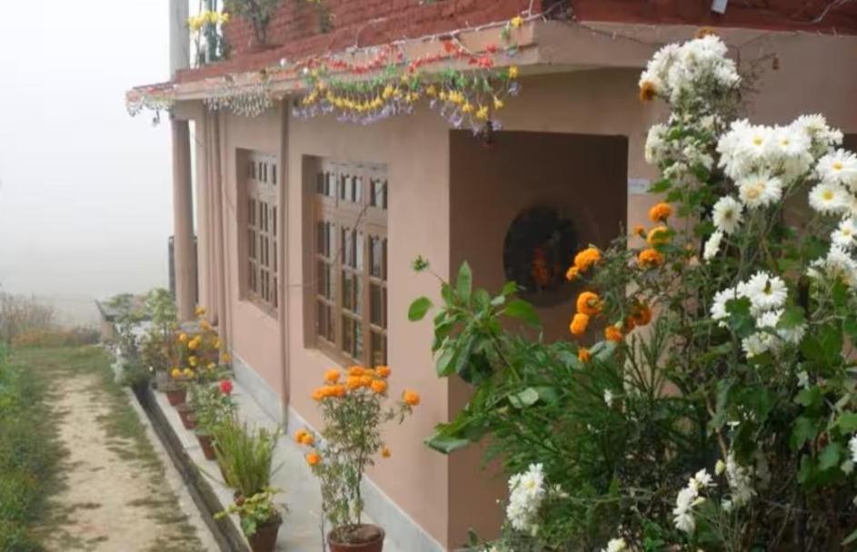 a pink building with flowers on the side of it at Sanjog's B&B in Bhaktapur