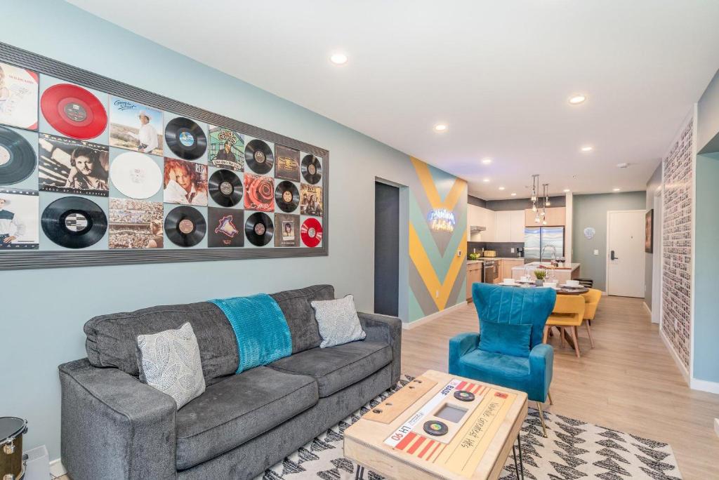 a living room with a couch and a table at Hyve - Neon Lights - Pool & Gym - Walk to Broadway in Nashville
