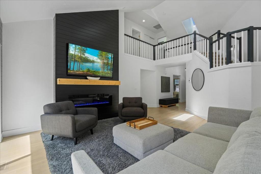 a living room with a couch and chairs and a tv at Lake, Hot Tub, Golf Retreat in Hayden Lake