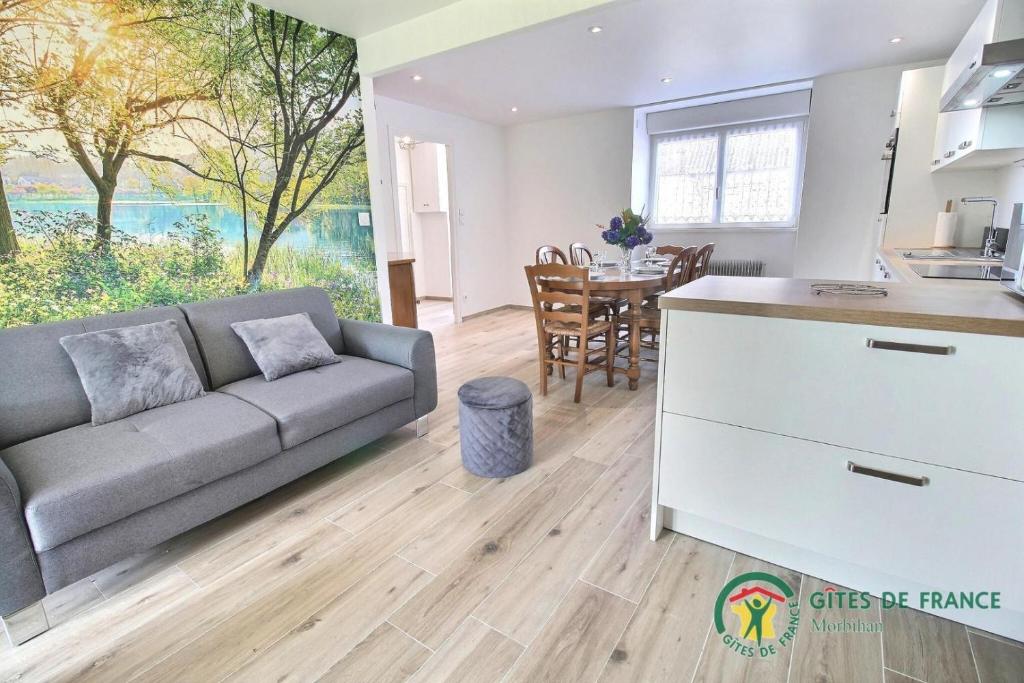 a living room with a couch and a table at Gite de kermativan in La Trinité-Surzur