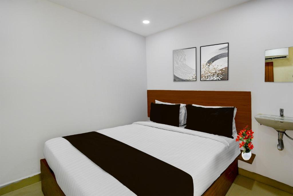 a bedroom with a large bed and a sink at Super Collection O L.B Nagar Metro Station Formerly D N Groups in Surūrnagar