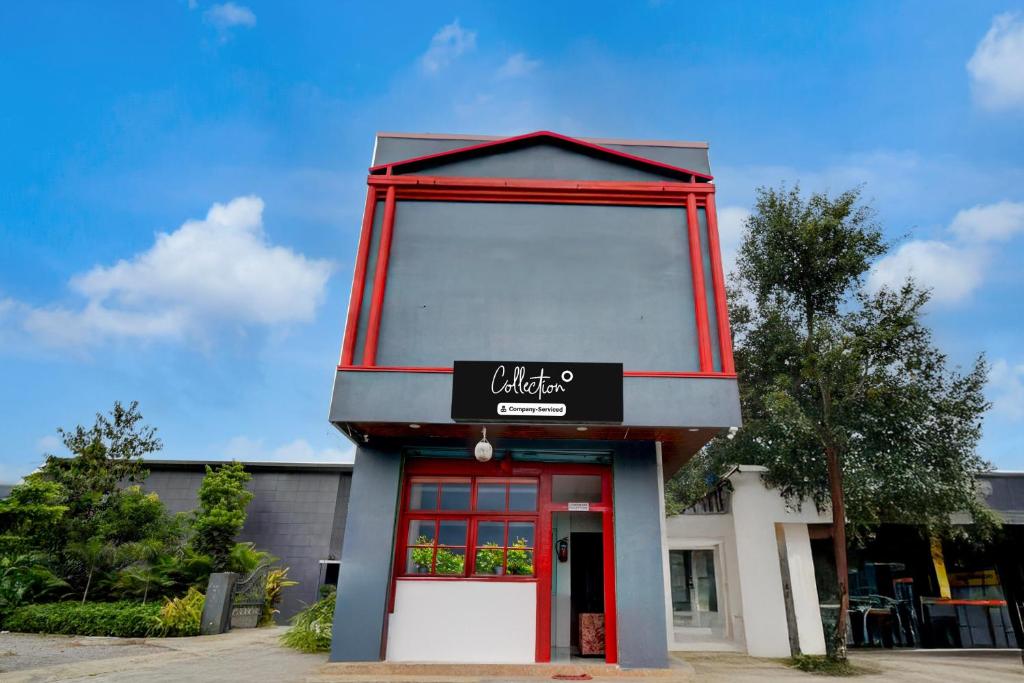 a building with a red door with a sign on it at Super Collection O L.B Nagar Metro Station Formerly D N Groups in Surūrnagar