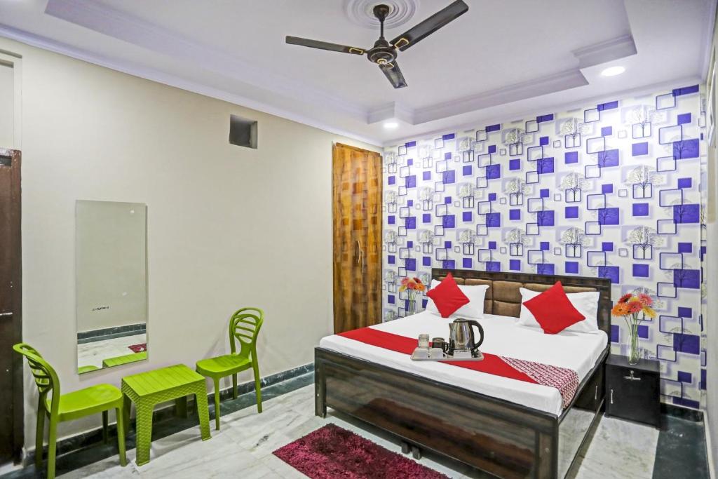 a bedroom with a bed and a table and a chair at Hotel O Metro Inn in Noida