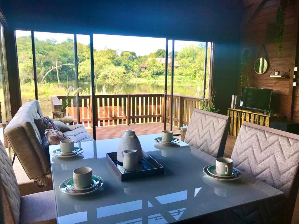 a living room with a table with cups on it at Cabana Gehrke in Nova Petrópolis