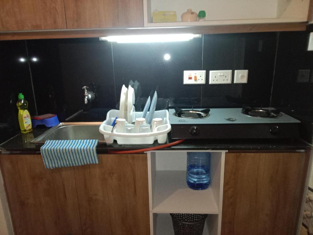 a kitchen counter with a sink and a stove at CK place in Nairobi