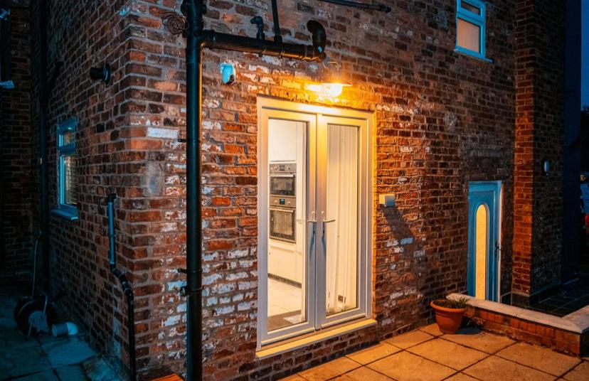 a brick wall with a door on the side of a building at Cozy room 1 in Sale