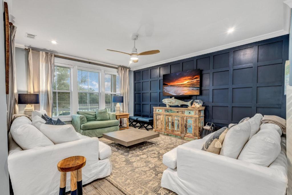 a living room with white furniture and a blue wall at 28 Hammock Breeze Way in Hilton Head Island