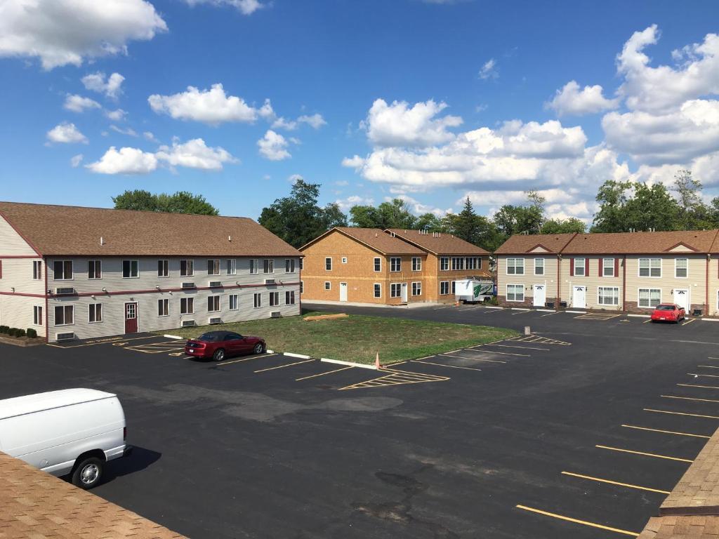 a parking lot with a row of brick buildings at Stay Inn and Suites in Niagara Falls