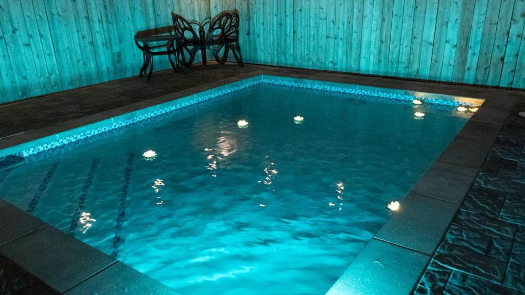 a swimming pool with a table and a chair in it at 200 Steps to Beach Private Pool 2 Big Levels apts in South Padre Island