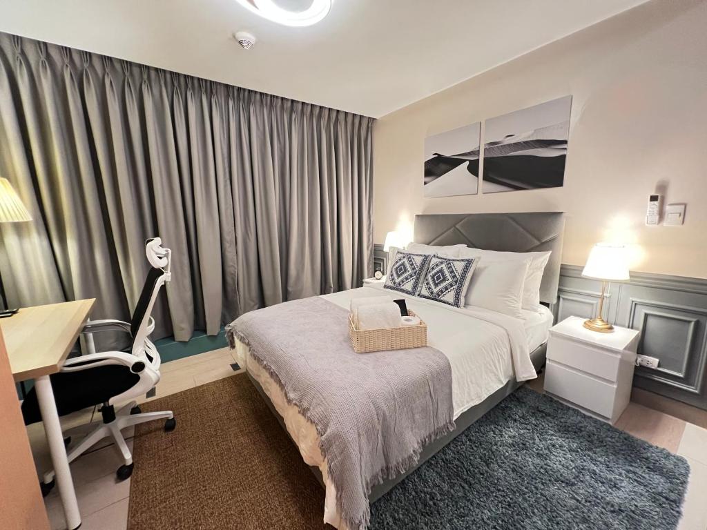 a hotel room with a bed and a desk and a desk at 1BR - Uptown BGC Taguig in Manila