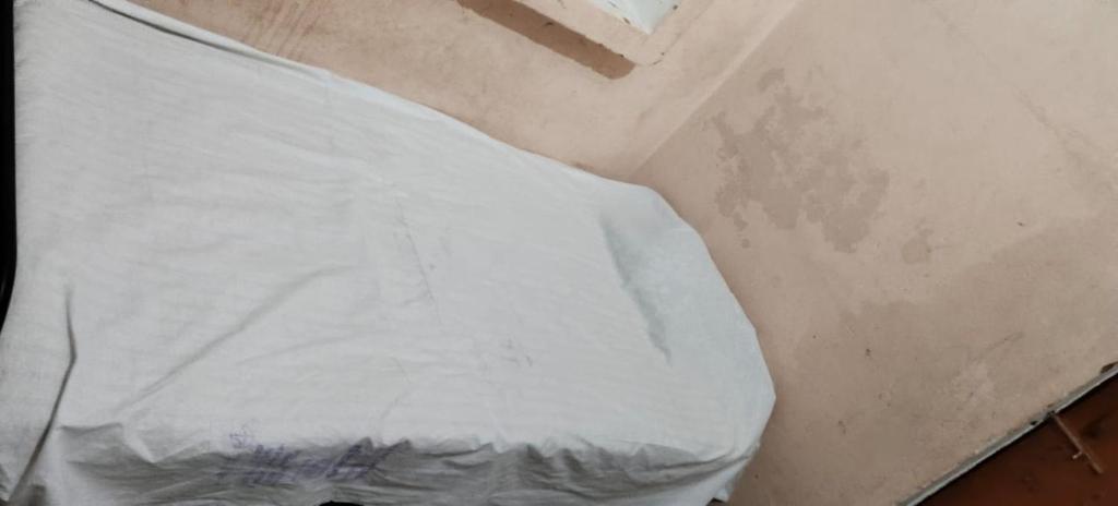 a close up of a persons back with a white shirt at Rk home stay in Jhūsi