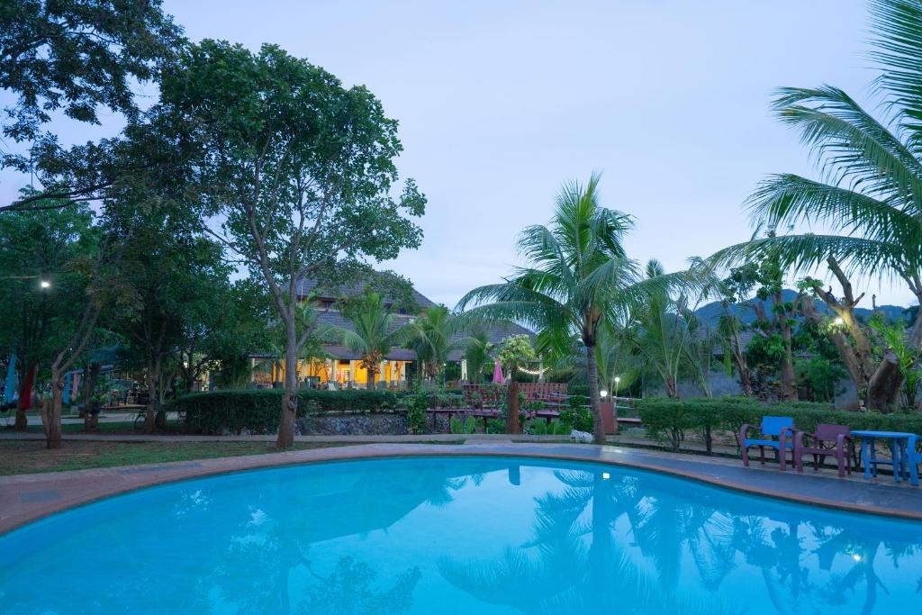 a swimming pool in front of a resort at Khaoyai Nature Life & Tour Resort in Nong Nam Daeng
