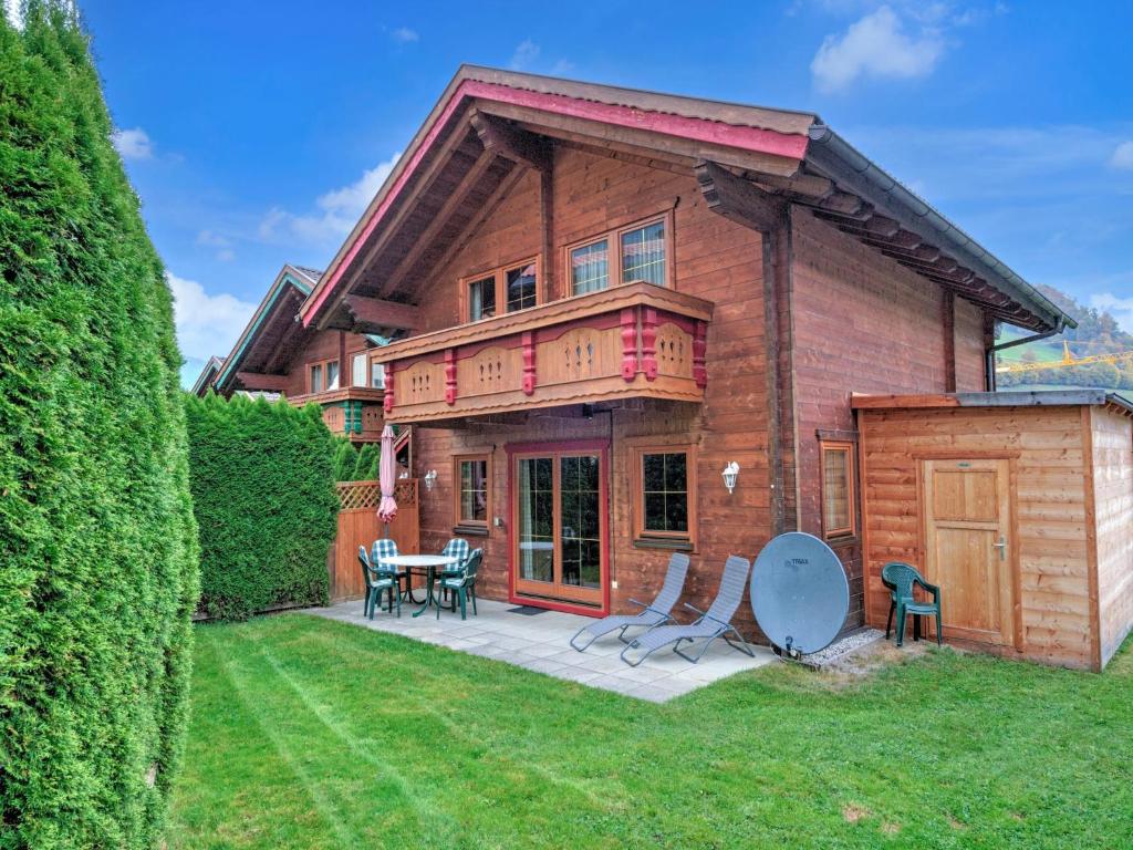 a house with a patio with a table and chairs at Holiday Village Wildschönau Traditional Chalet in Niederau