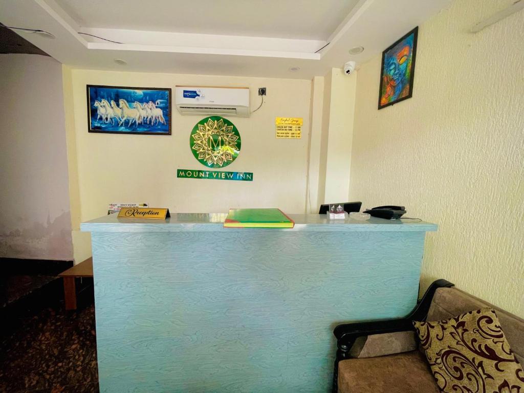 a blue bar in a room with a couch at Hotel Mount View Inn with terrace Ganga view in Rishīkesh