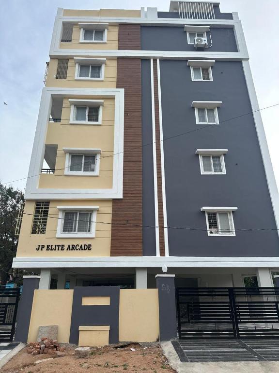 a tall building with a sign on it at CC Elite Homestay in Hyderabad