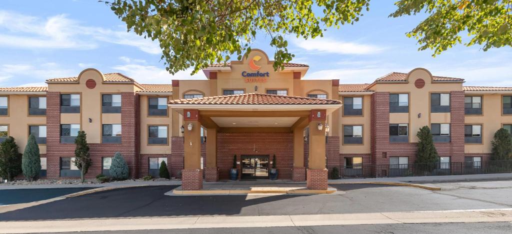 a large brick building with a large entrance at Comfort Suites Lakewood - Denver in Lakewood