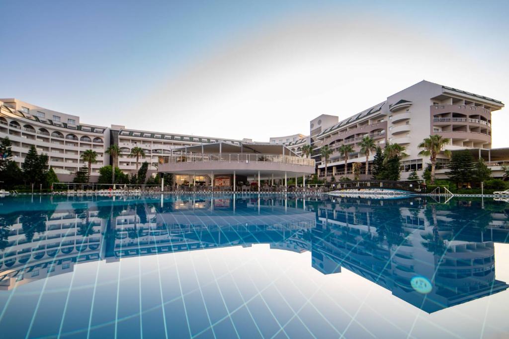 a large swimming pool in front of a building at Vita Silva Hotel in Kızılot